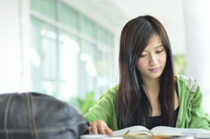 young asian student  reading