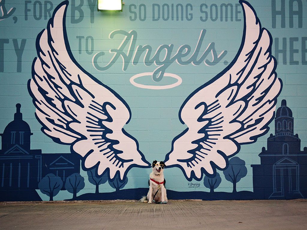 Mahle posing in front of a wall mural