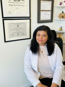 Dr. Rachana Patel sits in her home office where she provides remote eye care.