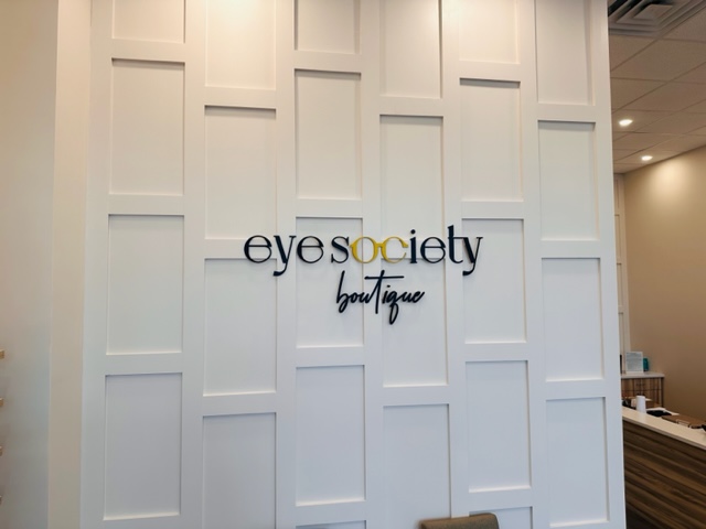 eye society boutique logo on a paneled wall is eye catching