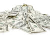 Loan and Debt Resources Pile ofdollar bills on white background representing profit sharing