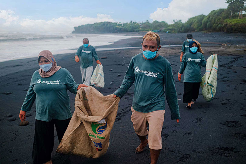 A photo of people cleaning up a beach