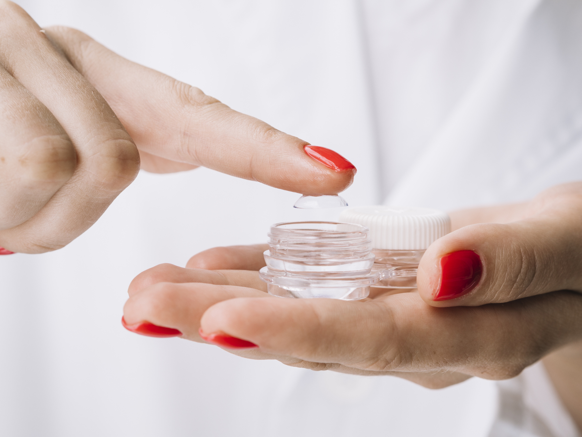 Female pulling out contact lenses from box High quality beautiful photo concept,Romania