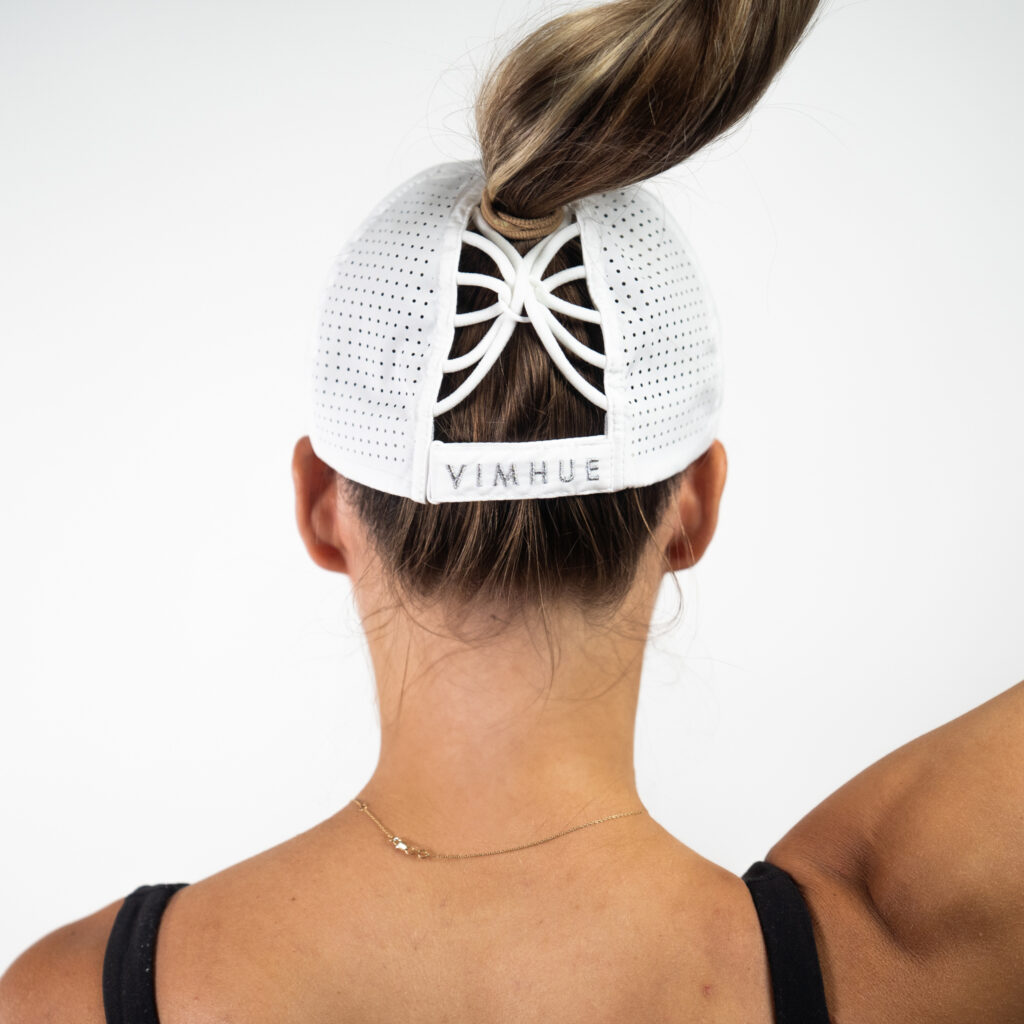 white hat designed to hold high or low ponytail