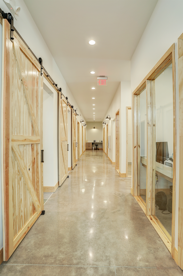 sliding barn doors reveal exam lanes in light airy office