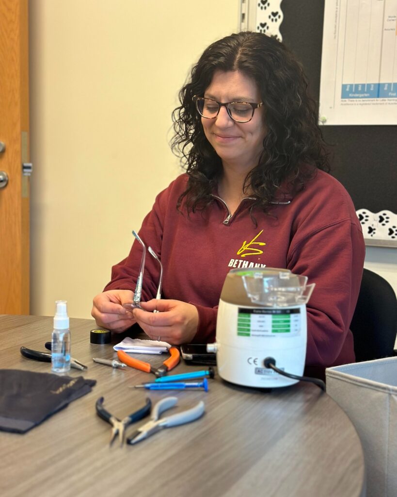 Bethany Shaw sets up in a classroom where she fixes students' eyewear.
