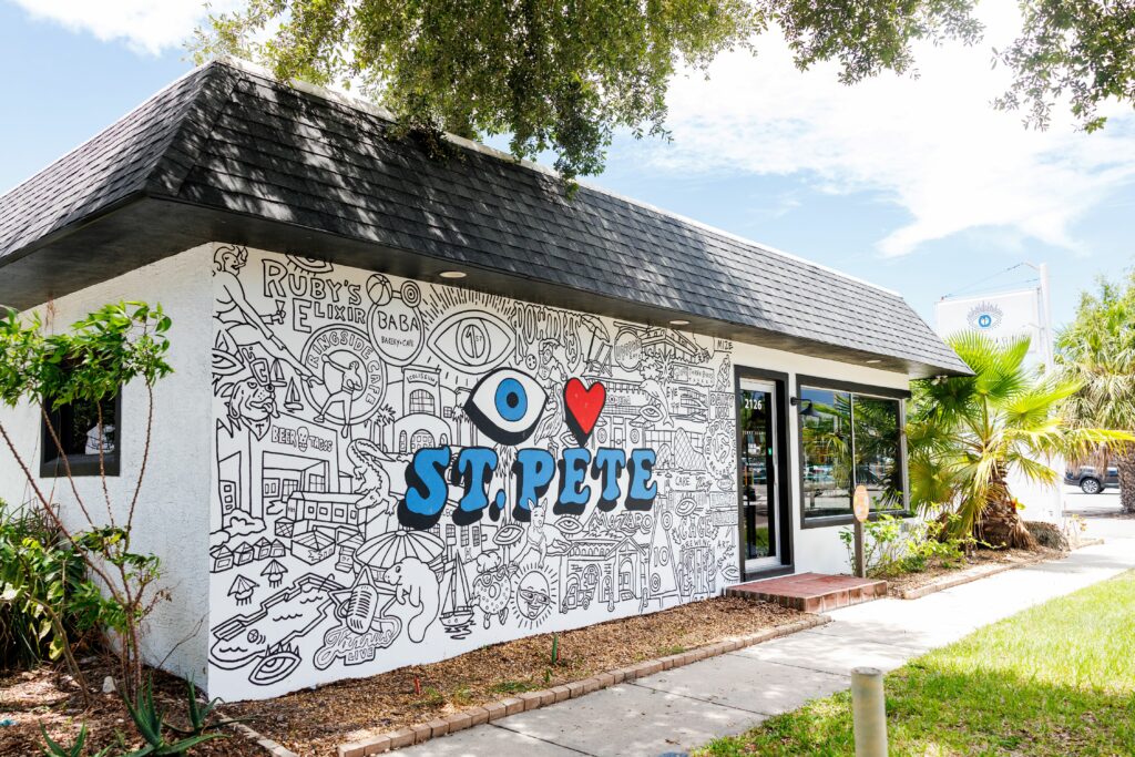 the side wall of Dr. Geary's practice is all black and white line drawings and blue words that say "eye" love st. pete