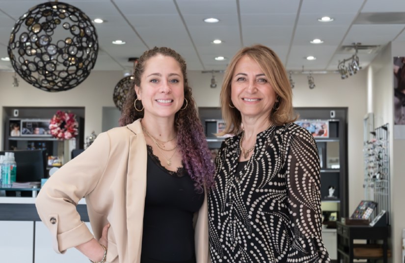 Sarah Veasquez and Dr. Mitra Madison standing in their office, talking about their ABB business partnership