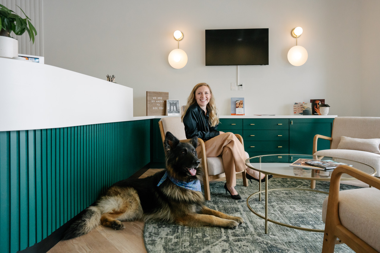 Dr. Portner in the optical with her German Shepherd, Berkley