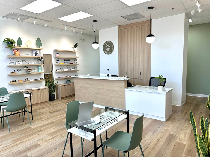 a photo of the office, featuring white, beige, wooden and green furniture