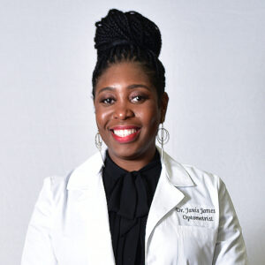 Dr. Janis James in white coat and black blouse