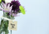 What Are Your Staff Motivation Strategies? green and purple flowers in a vase with thank you note tied around it