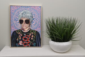 painting of golden girl Sophia next to a plant in the bathroom