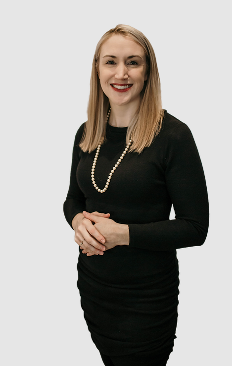 Dr. Kim Cooper in black dress, pearls, against white background