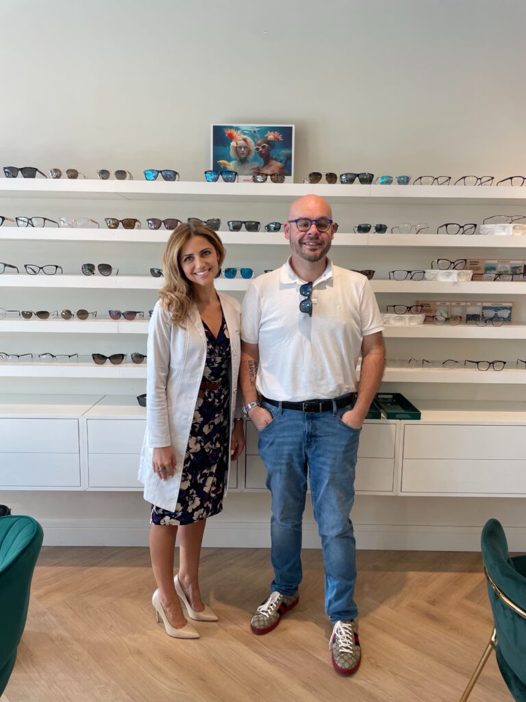 doctor and the patient she diagnosed standing in front of frame display