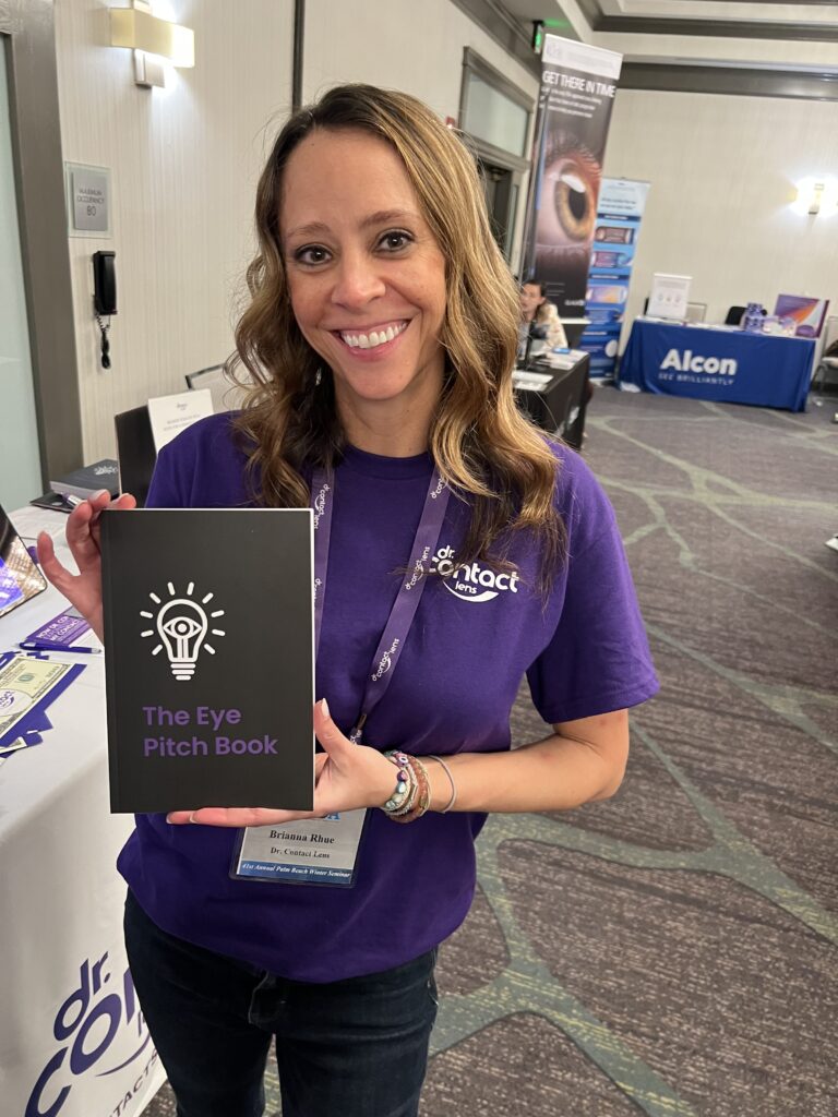 Dr. Rhue holding the Eye Pitch Book