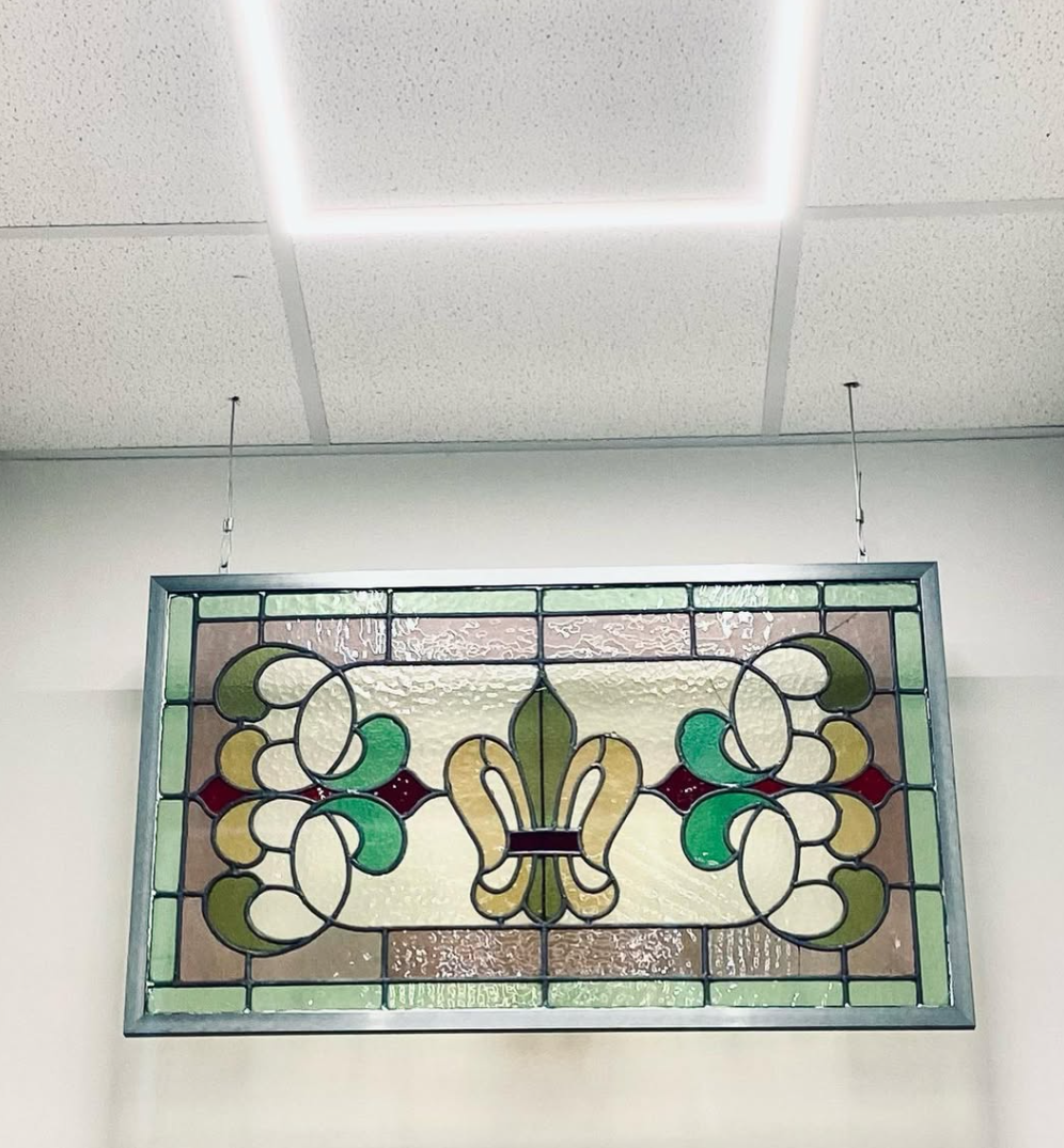 a piece of green and brown stained glass