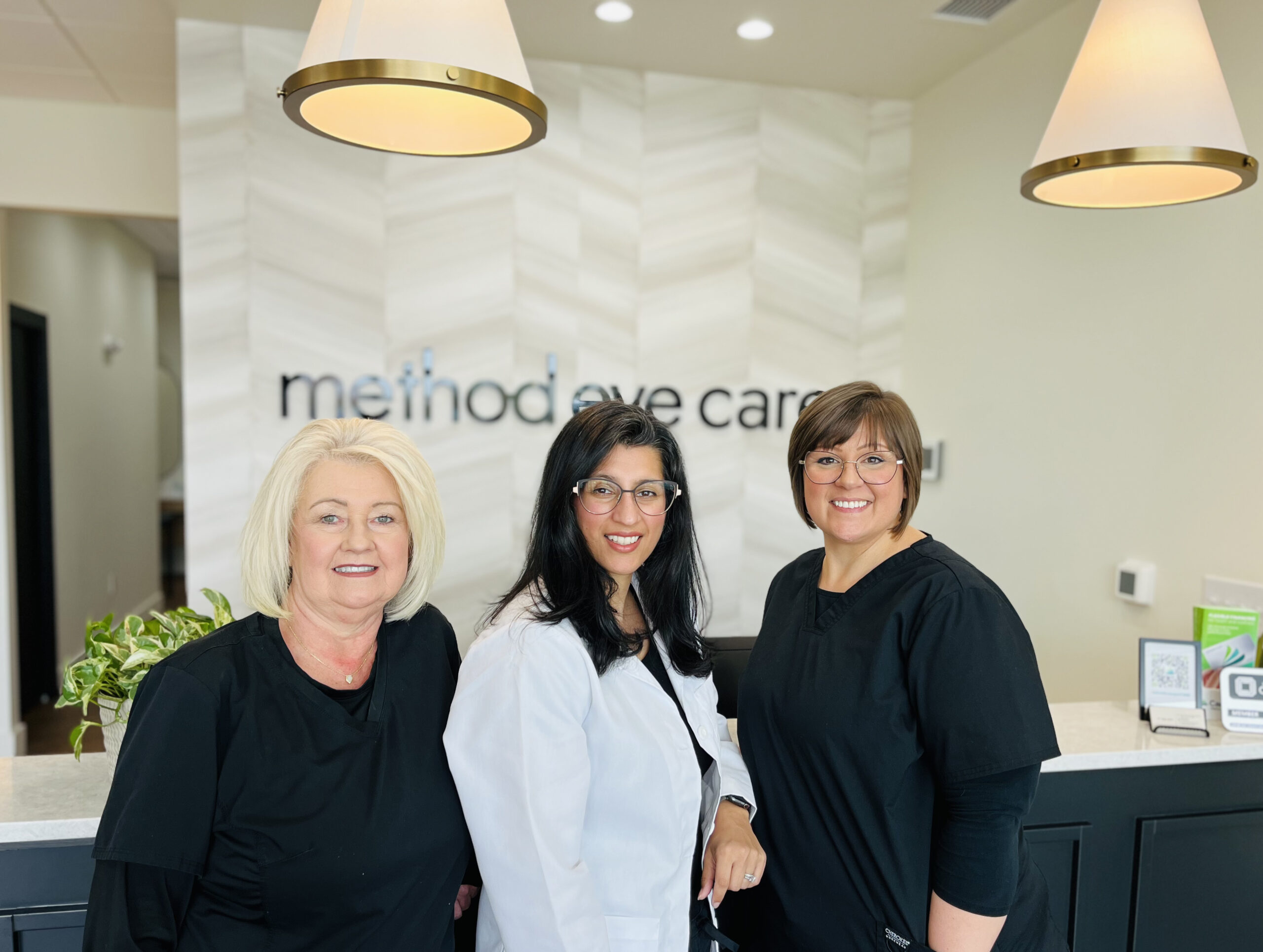 Dr. Dada with optician Sandra (left) and patient care coordinator Jolene (right)