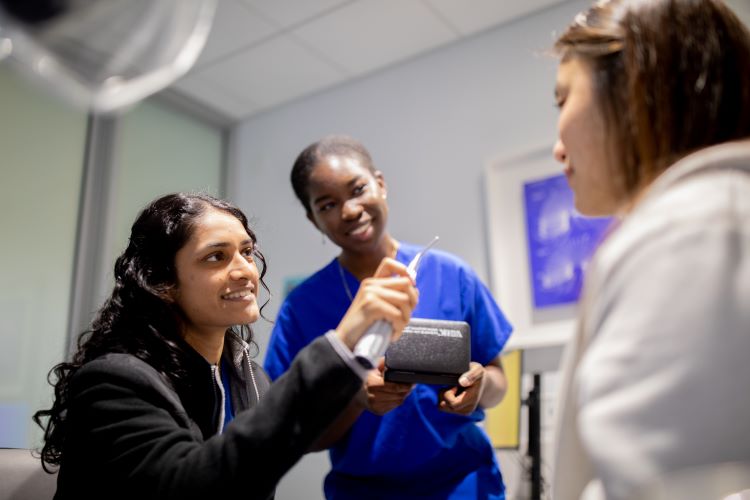 three students in clinic