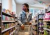 “Should I Still Wear a Mask?” woman wearing mask in grocery store