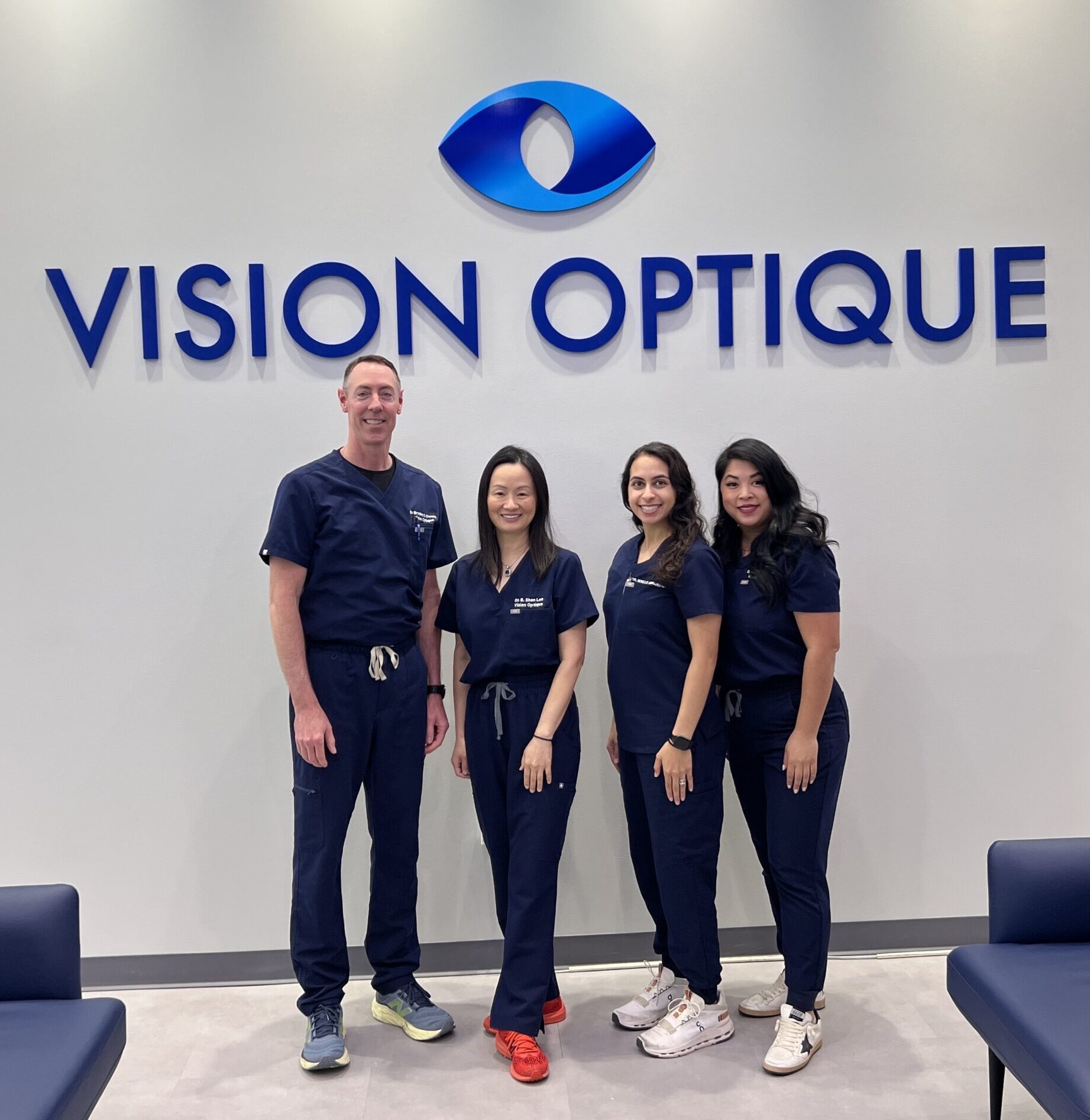 Vision Optique doctors stand under the new vision optique logo