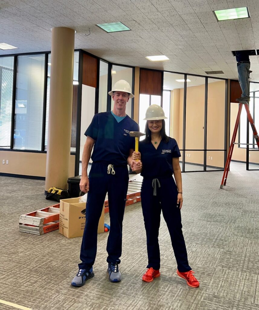 Dr. Owens and Dr. Shen Lee in the space under construction wearing hard hats