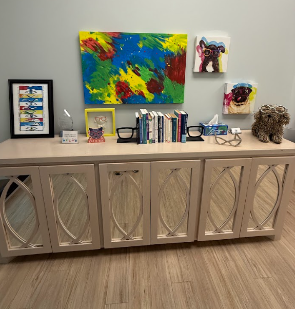 The office features fun artwork and toys and books galore