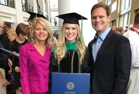 mother and brother stand next to new optometry school graduate