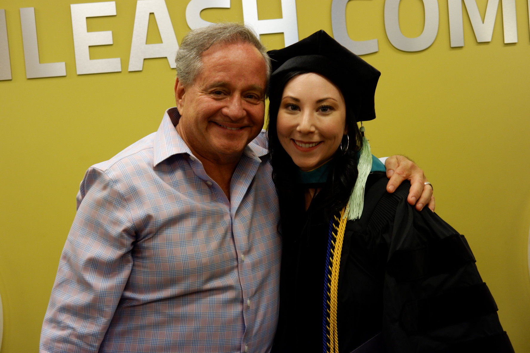 Dr. Goldberg during her 2019 graduation from Southern California College of Optometry, posing with her childhood optometrist, Dr. Stephen Cohen, who she has been in practice with for more than seven years.